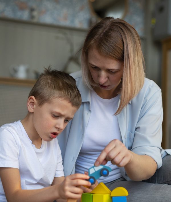 mother-playing-with-her-autistic-son-using-toys
